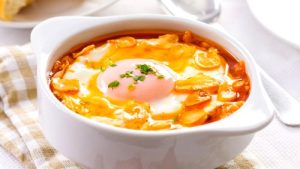 Tasty garlic soup with fried garlic clices and egg.
