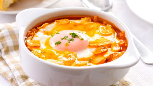 Tasty garlic soup with fried garlic clices and egg.